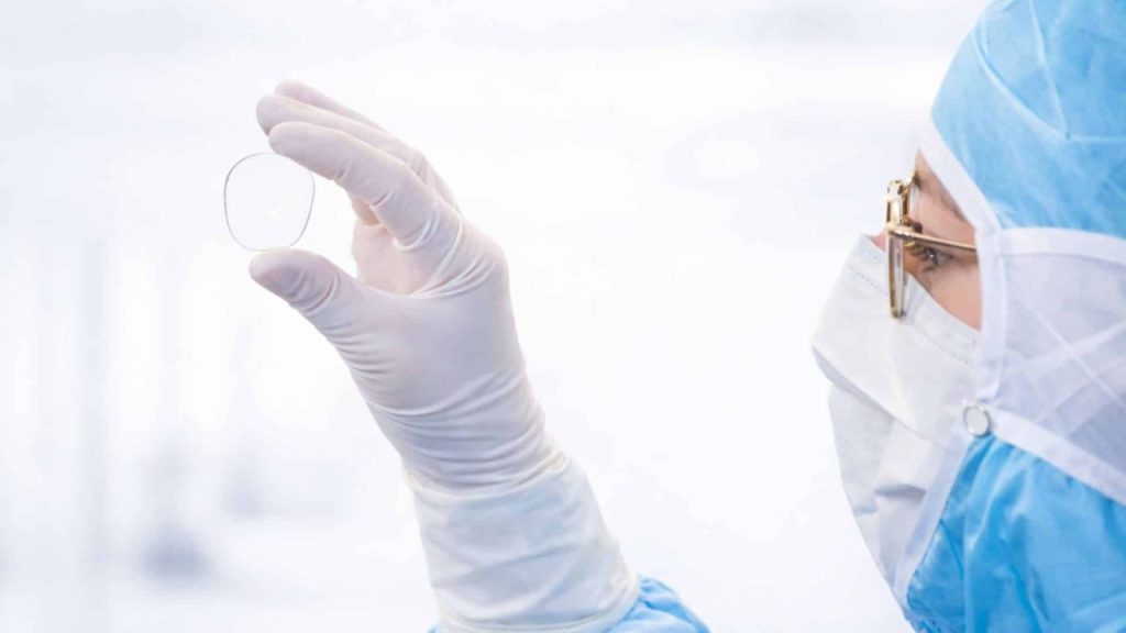 Engineer assembling compact optical hardware module for smart glasses in a Lausanne lab