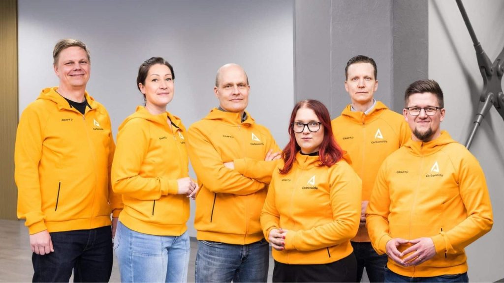 Engineers inspecting low-carbon concrete blocks produced with Carbonaide carbonization technology in a Finnish industrial facility