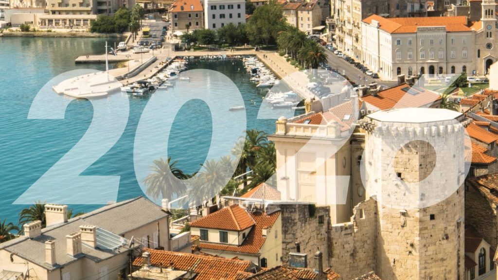 A modern coworking space in Croatia with startup founders collaborating around laptops and whiteboards