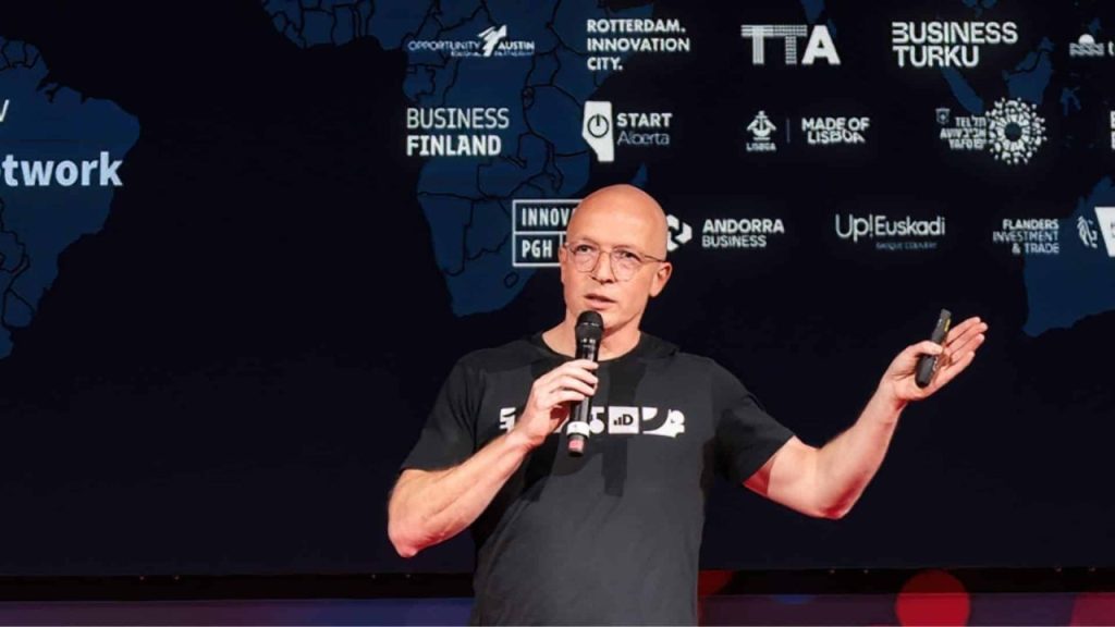 Dealroom.co data platform interface visualized over a global startup and venture capital network map