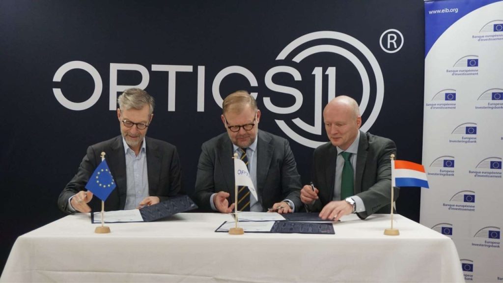 Optics11 laboratory with advanced fiber-optic sensing equipment and engineers testing industrial hardware