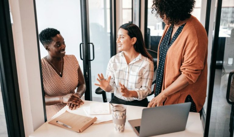 Founders reviewing a startup hiring plan on laptops after closing a Series A funding round