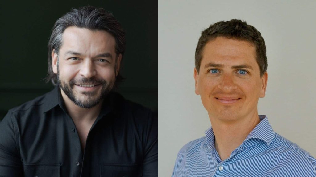 Two startup founders shaking hands in front of a digital sustainability and data analytics dashboard