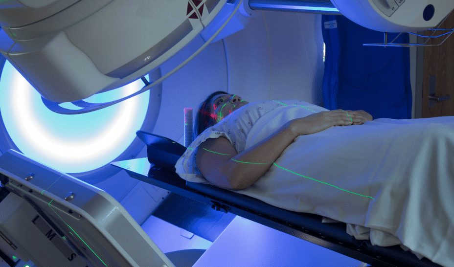 Oncology researcher analyzing cancer survival data on digital screens in a modern medical lab