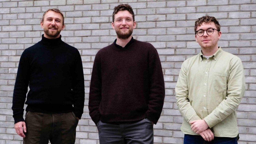 Researchers using AI software to analyze advanced materials data in a modern laboratory