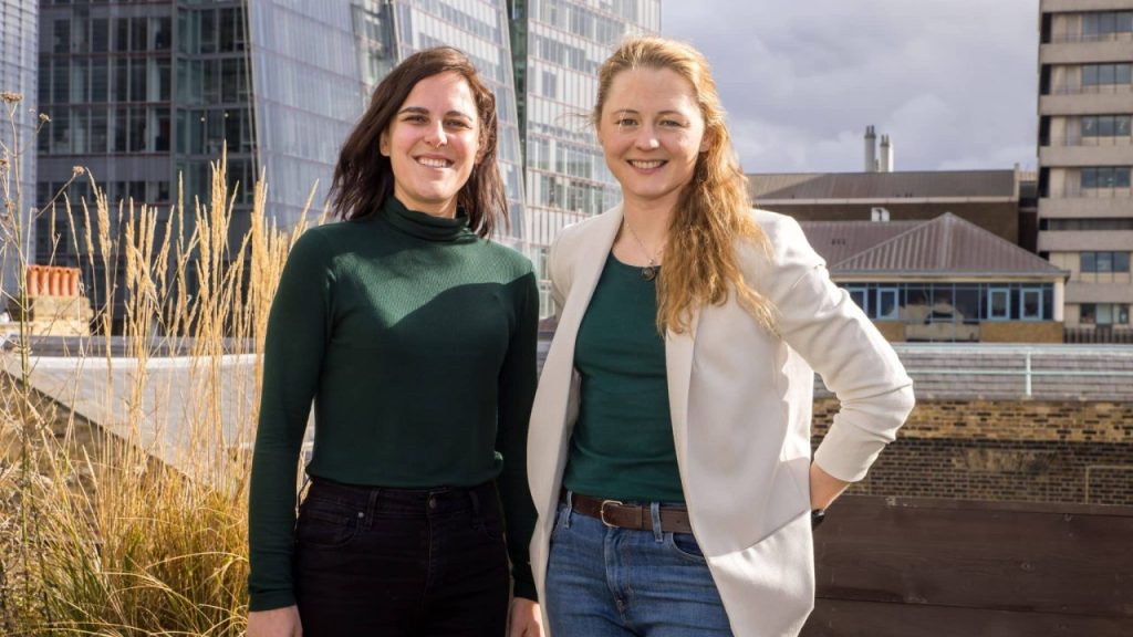 Female-led UK construction tech team collaborating on data-driven tools at a building site
