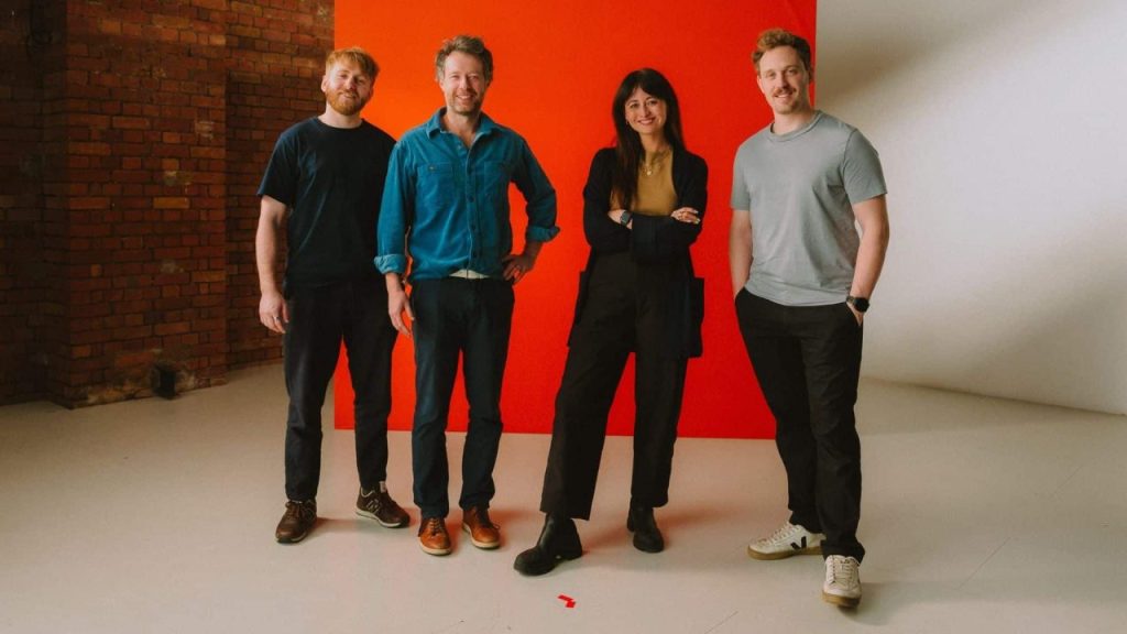 London-based energy fintech tem office with digital grid and payment data visualizations on screens