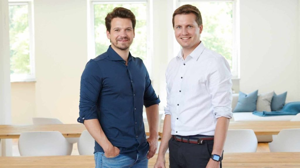 TWAICE engineers analyzing battery performance data on large digital dashboards in a modern Munich office