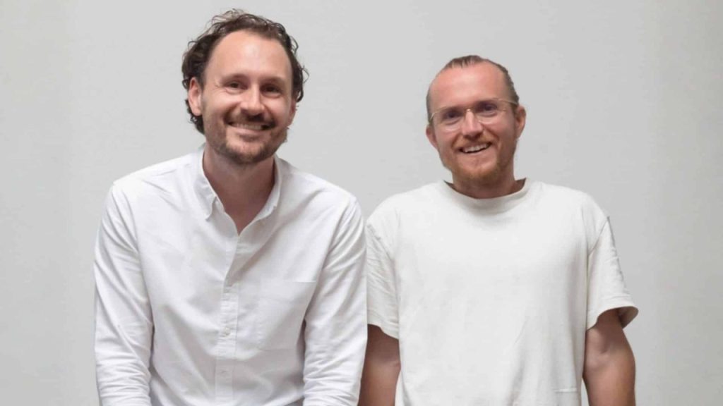 Team of frontline workers using a voice AI platform on mobile devices in an industrial setting