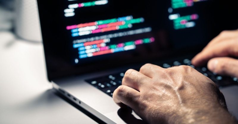 Cyber Liability and Data Breaches: How to Protect Your Business Business professionals reviewing cybersecurity and cyber liability strategy on laptops in a modern office