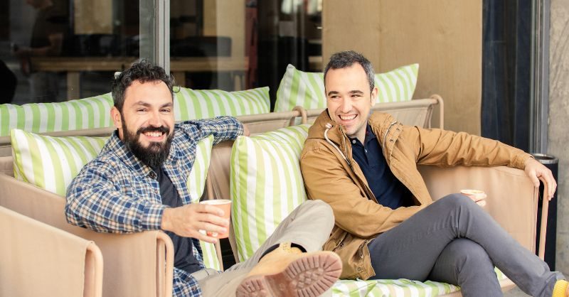 Factorial targets $200M round to become Spain’s top startup Office team collaborating in front of screens displaying HR software dashboards, representing Factorial’s growth as a leading Spanish startup