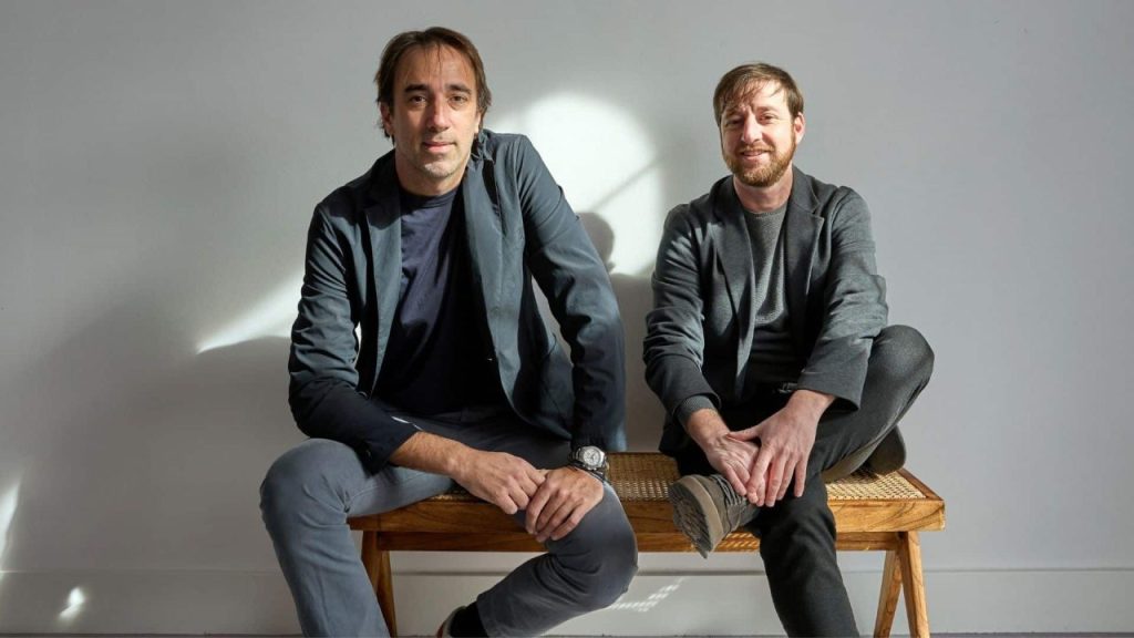 Medical staff in a modern hospital control room analyzing AI-driven data dashboards on large screens
