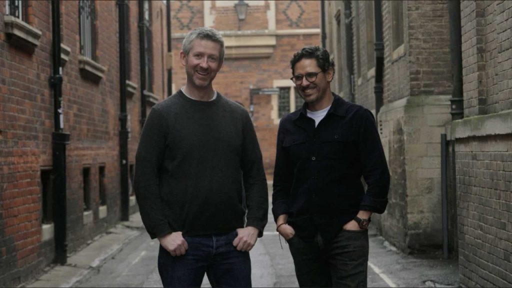 Multiple autonomous drones flying in coordinated formation over a critical infrastructure site at sunset