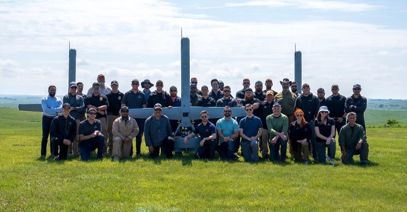 Shield AI Secures $2B from Advent to Scale Hivemind Platform Shield AI engineering and leadership team posing together in an office setting