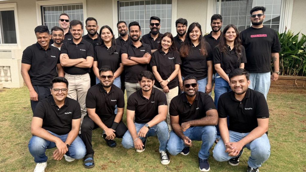 VerbaFlo and Pi Labs team members discussing AI real estate agent technology in a modern office setting