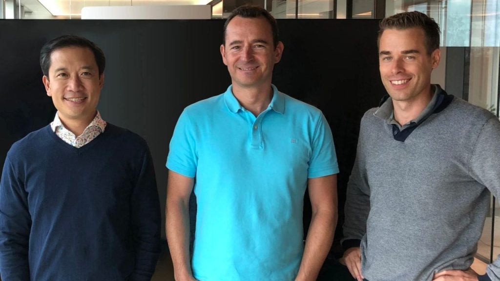 Engineers inspecting Magnax axial flux electric motor prototypes in a high-tech manufacturing facility