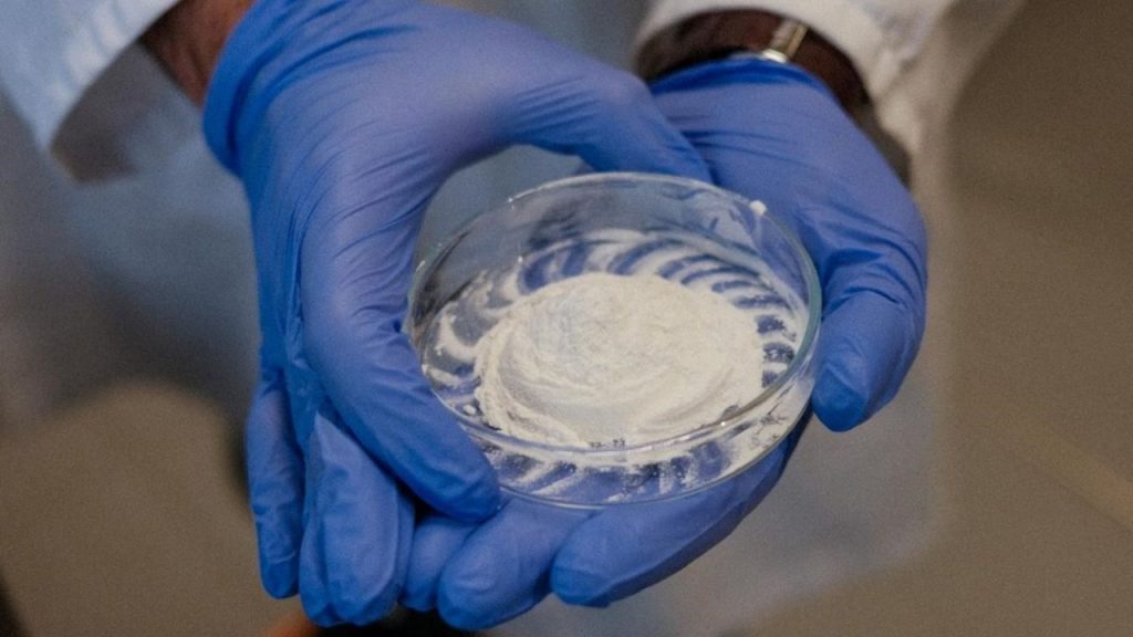 Naturbeads logo with biodegradable microbeads in a laboratory setting.