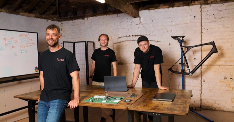 Tyred Secures £2.5M to Launch Predictive Bike Maintenance AI A close-up of a bicycle wheel with a digital overlay representing AI-driven diagnostic sensors.
